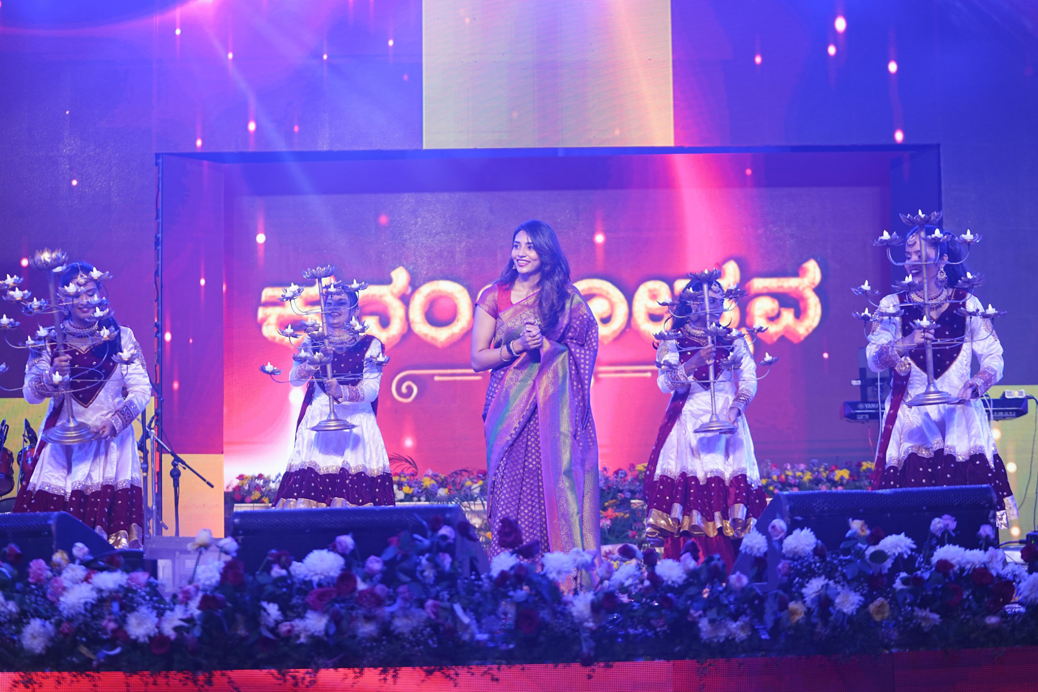 On-stage event performance with dancers and colourful production